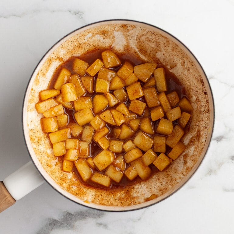 sauteed cinnamon apples in a white pot