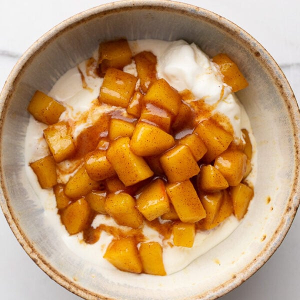 soft cinnamon apples on top of vanilla ice cream