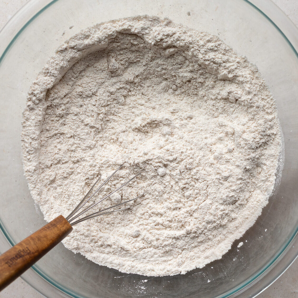 Whisking together flour with baking powder and brown sugar.
