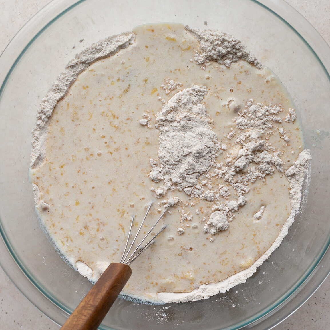 Mixing together the waffle batter in a large bowl.
