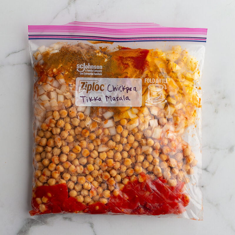 freezer bag labeled "Chickpea Tikka Masala" and filled with ingredients to make Chickpea Tikka Masala