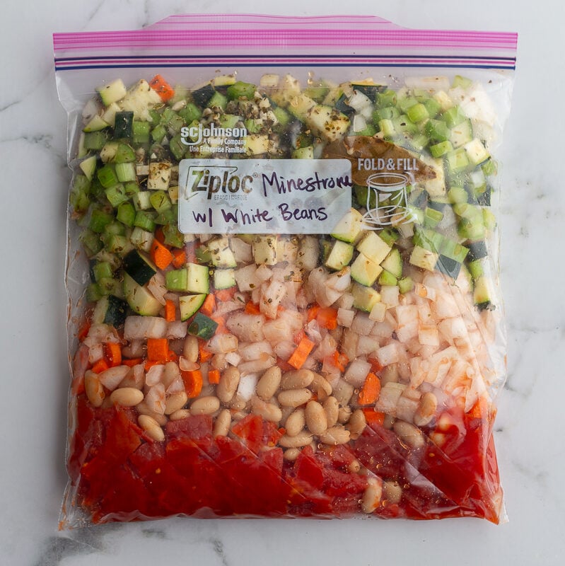 freezer meal of Minestrone with White Beans in a freezer bag and labeled with the recipe title