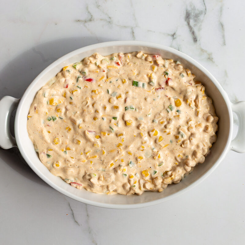 cream cheese corn dip in an oval dish