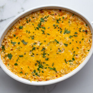 cream cheese corn dip in an oval dish