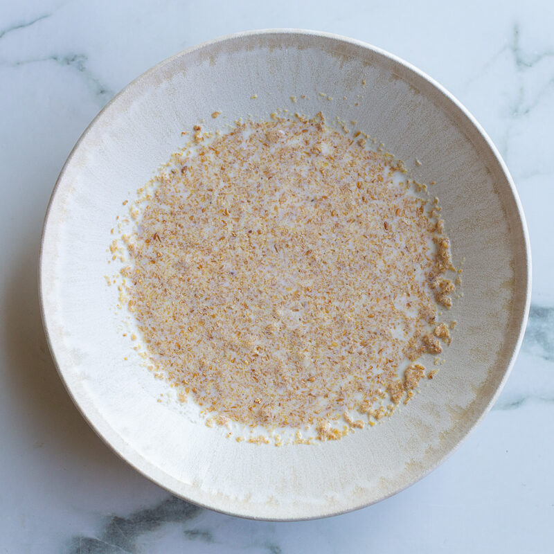 flaxseed meal mixed with milk in a shallow bowl