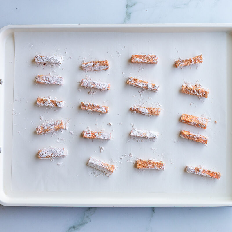 flour covered sweet potato sticks before being baked