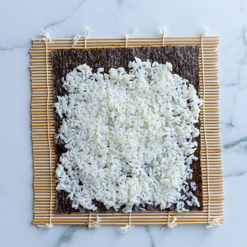 rice spread on a nori sheet to make sushi